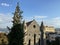 Old vintage medieval stone church building surrounded with trees.