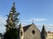 Old vintage medieval stone church building surrounded with trees.