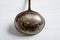 Old vintage metal soup ladle on a table