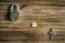 Old vintage padlock and key on wooden texture