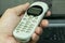 Old vintage push-button cordless phone in hand,