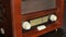 Old vintage radio with brown wooden background.