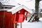 Old vintage red wooden mail post box in the countryside village in winter