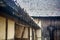 Old vintage roof of cottage with pouring rain