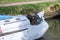 Old vintage rusty hand winch and anchor on the stern of a boat on the Kennet and Avon Canal