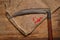 Old vintage scythe of the last century extracted from the chest in the workshop of grandfather. Background for craftsmanship and