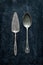 Old vintage silverware (cutlery) on black - top view