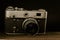 old vintage soviet camera with lens on wooden background