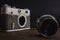 old vintage soviet camera with lens on wooden background