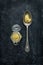 Old vintage spoon and mustard jar on black chalkboard - top view