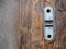 Old vintage steel lock of garage roll door on wooden floor