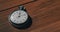 Old Vintage Stopwatch Lies on Wooden Table and Counts the Seconds