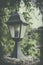 Old vintage street lamp lantern with green leaf tree.