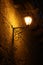 Old vintage street lantern on a brick wall, night background, victorian vintage style