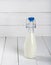 Old vintage style bottles with fresh milk on wooden table