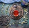 Old vintage tea setting with cup of herbal tea and fresh healing herbs and wild flowers on dark rustic background, top view.