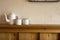 Old vintage teapot and two cup of tea on wooden shelf, antique