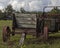 Old Vintage Thresher in front of Abandoned barn