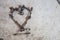 old vintage tools and parts laid flat on concrete in love heart shape