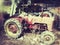 Old vintage tractor abandoned in a barn red rusty dust machinery agriculture Suffolk uk