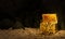 Old or vintage treasure chests or chests with gold coins spread out on the sand with a cliff background or cave rocks. 3D