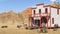 Old vintage western saloon isolated on the field in Wild West, 3d rendering