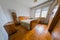 Old vintage wooden bedroom in an old house. Visible old bed, wardrobe closets and small bedside cabinets