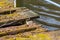 Old vintage wooden bridge aging and overgrown with moss decomposing in ramshackle style corroding and ailing as rotten footpath