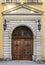 Old vintage wooden doors in an ancient architectural building with vintage wrought-iron lanterns