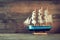 Old vintage wooden white sailing boat on wooden table