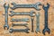 Old vintage wrenches on wooden background. Top view