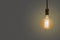 Old vintage yellow  electric lightbulb on beige background