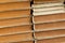 Old vintage yellowed pages of books stand in rough texture side view wide