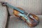 Old violin, beautiful wood, classic style, brown fabric background