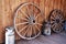 Old wagon wheels and milk cans on a farm