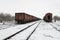 Old wagons on the railway in the snow in winter.