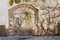 Old wall covered with dry ivy and obsolete brick arch. Background texture