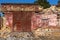 Old wall of destroyed house. Old powder wall with walled window and gates, doors. Ruined house. Remains of old houses. Apocalypse