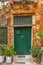 Old wall with green locked door