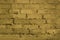 The old wall is made of yellow, worn brick. Light background.