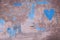 Old wall with paint spots, abstract texture background. Burgundy, gray, brown, blue colors, gradient. Blue hearts