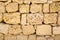 Old wall of porous sand stone bricks, close-up