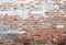 Old wall of red brick cracked