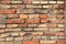 Old Wall of Red Bricks and White Brayed and Cracked Old Paint. Red, Terracotta and White Brick Background. Old Wall for Background