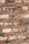 Old wall of rows of large blocks and rows of small bricks. Vertical photo