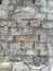 Old wall texture with crumbled, chipped, cracked white brick