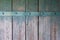 Old wall of wooden planks painted with paint with iron strip