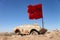Old War Machine Fighter at Iran Iraq War Battlefield Desert with Red Flag