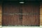 Old warehouse as dark brwon wooden sliding door with brown brick wall