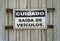 Old warning sign in portuguese informing `CAUTION VEHICLE EXIT`